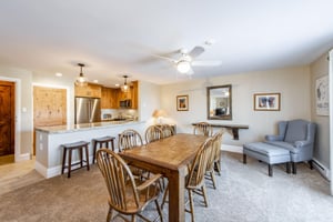 Gather around the large dining table for meals and memories, with the fully equipped kitchen just steps away. An ideal setup for groups staying at this popular Park City vacation rental.