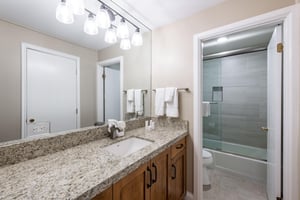 This wellappointed bathroom features a generous vanity with granite countertops and a glassenclosed shower, providing a clean and comfortable space to refresh during your Park City vacation rental s