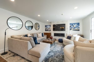 Gather around the fireplace and flatscreen TV in this spacious and stylishly appointed living room, featuring generous seating and elegant décor throughout. The perfect setting for evenings in at thi