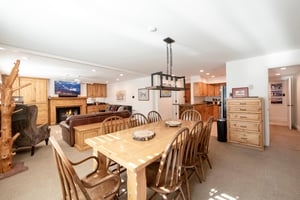 This warm and inviting dining area sits at the center of the home, connecting seamlessly to the kitchen, living room, and fireplace for a truly communal and comfortable Park City vacation rental exper