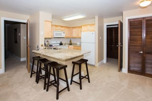 Resort Plaza 5040 — This bright and functional kitchen features light wood cabinetry, a granite breakfast bar with seating, and all the essentials needed for convenient meal preparation during your Pa