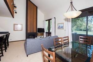 Three Kings 37 offers a bright and inviting living and dining space centered around a classic wood burning fireplace, creating a warm and cozy atmosphere that makes this Park City condo rental the per