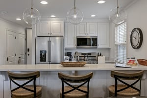 Cooking is a pleasure at Three Kings 83 — bright white cabinetry, a generous island, and modern finishes elevate every meal in this Park City condo rental.
