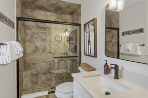 Refresh in style at Three Kings 83 — a beautifully updated bathroom with a stonetiled shower and clean contemporary finishes.