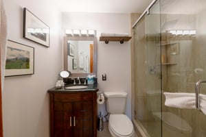Three Kings 93 features beautifully finished bathrooms with rich wood vanities, a walkin glass shower, and rustic accents that perfectly complement the mountain character of this exceptional Park Cit