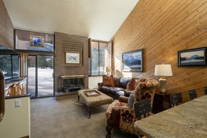 Sink into plush furnishings beside a crackling fire and let the mountain magic unfold — the comfortably appointed living room at Park Avenue 267 delivers a cozy Park City lodging experience in classic