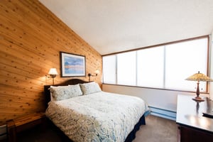 Wake up refreshed and ready for adventure in the warm and inviting bedroom at Park Avenue 267.