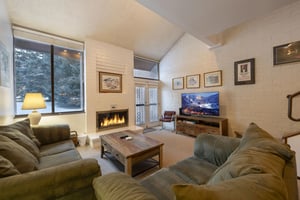 Kick back and relax in the inviting living room at Park Avenue 268. With a crackling fireplace and plenty of comfortable seating.