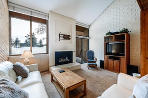 Settle in and relax in the cozy living room at Park Avenue 292. Complete with a gas fireplace and comfortable furnishings.