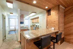 The granite breakfast bar at Park Avenue 292 is perfect for casual meals and morning coffee before hitting the slopes.