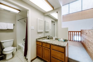 The bright and wellappointed shared bathroom at Park Avenue 292 features granite countertops and plenty of natural light.
