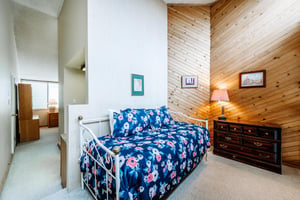 The charming loft bedroom at Park Avenue 292 features a daybed with trundle, making it a versatile and practical space for additional guests.