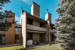 The striking exterior and patio of Park Avenue 297 make a lasting first impression. Nestled among mature trees and adjacent to the golf course.