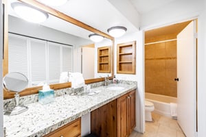 The full bathroom at Park Avenue 333 combines warm wood cabinetry and a tubshower combo for a comfortable guest experience. Thoughtful finishes like these make this Park City vacation rental a cut ab