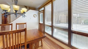 Bright, warm, and perfectly inviting — the dining area at Pay Day 189 is bathed in natural light with a peek at the private hot tub just outside the window.