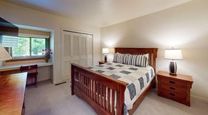 This beautifully furnished bedroom with a classic wood bed frame and plush bedding is your perfect mountain retreat after a day of adventure. This Park City lodging choice is perfect for a great night