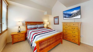 Cozy, bright, and full of mountain charm — this cheerful bedroom at Pay Day 189 features a Smart TV and a comfortable bed to sink into after a big day on the slopes.