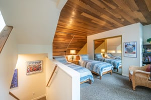 The cozy loft twin bedroom at Pay Day 183 features soaring woodpaneled ceilings and plenty of space for the little ones. This Park City vacation rental is the perfect rental that the whole family wil