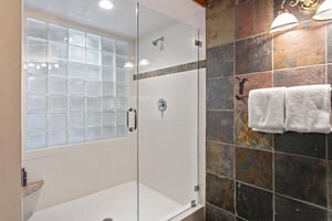 Freshen up in the sleek, modern walkin shower at 1296 Pinnacle — a toprated Park City vacation rental near Deer Valley Resort, where stylish slate tile finishes and glass block accents elevate every