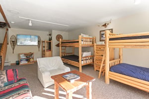 Spacious and fun for the whole family, the bunk room at 1296 Pinnacle doubles as a cozy lounge area — making this Park City vacation rental near Deer Valley Resort the perfect home base for groups and