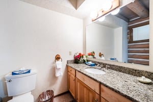 Every bathroom at Temptation 8 is stocked and ready for your arrival, offering granite countertops and classic wood finishes that add a warm, homey feel to this Park City condo rental.