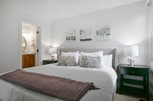 Rest and recharge in style in the elegant king bedroom at Three Kings 64, where plush bedding, tasteful artwork, and a serene neutral palette combine to offer a truly restful experience in this premie