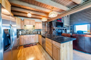 Gather, cook, and entertain at Temptation 8, where the beautifully appointed kitchen with granite countertops and custom cabinetry opens directly to the cozy living space.