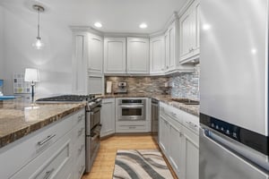 Every detail of the gourmet kitchen at Three Kings 64 has been thoughtfully designed, from the elegant mosaic tile backsplash and granite countertops to the premium stainless steel appliances.
