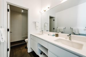 Three Kings 80 continues its modern aesthetic into the bathroom, featuring a sleek double vanity and clean, contemporary finishes.