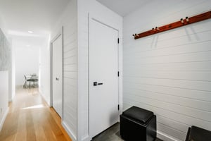 Three Kings 80 welcomes guests in style with a sleek, modern entryway featuring shiplap walls and thoughtful storage.