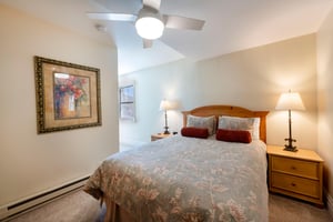 Cozy and inviting, this warm bedroom at Resort Plaza 5004 is the perfect place to recharge after a busy day.