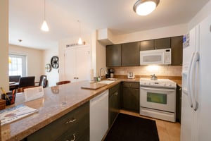 Resort Plaza 5007 has all the comforts of home — this stylish kitchen features sleek dark cabinetry, full appliances, and a convenient breakfast bar perfect for casual mornings before hitting the slop