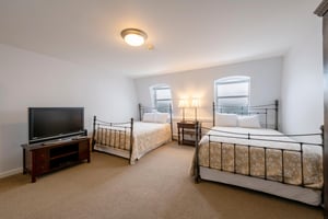 Bright, spacious, and perfect for the whole crew — this generously sized bedroom at Resort Plaza 5007 features two classic iron beds and plenty of natural light, ideal for families and groups.