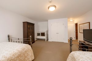 Spacious and versatile, the second bedroom at Resort Plaza 5007 offers plenty of room for the whole group — with classic iron bed frames, an elegant armoire, and ample closet space in this comfortable