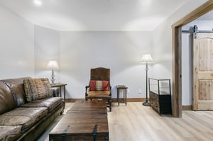 Sink into this comfortable living room with rustic leather seating and a cozy wood coffee table. Youll find a full kitchen just through the doorway, ready for your stay.