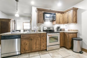 Your fullyequipped kitchen awaits with warm wood cabinetry, granite countertops, and stainless appliances—perfect for preparing homecooked meals during your stay.
