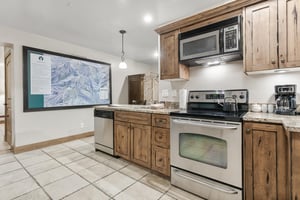Your fully equipped kitchen features granite counters, stainless appliances, and rustic wood cabinetry—everything you need to prepare delicious meals in comfort.