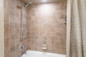 The private bathroom includes a tubshower combo with a rainfall showerhead — a nice way to unwind.