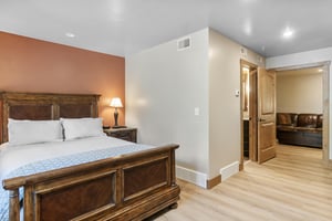 Plush bedding and soft lighting make this bedroom a comfortable end to any day in Park City.
