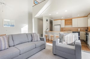 Settle into your lightfilled living space where comfortable seating flows into a fullyequipped kitchen—perfect for unwinding after exploring or preparing meals together.