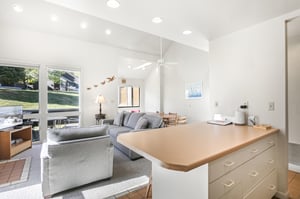 Relax in the lightfilled living space, where vaulted ceilings and glass doors leading to the patio bring the mountain setting indoors.
