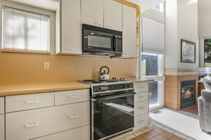 A wellstocked kitchen with fullsize appliances opens to the living area.