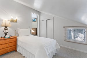 Crisp linens, thoughtful lighting, and plenty of storage make bedroom an easy fit for families sharing a Park City vacation rental.