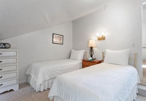 Tucked under sloped ceilings, this cozy twin room gives younger guests a space of their own to recharge for tomorrows Park City adventures.