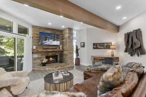 Natural light pours into the stylish open living space at Powder Run C13, where a crackling stone fireplace and modern furnishings make this Deer Valley condo rental the ultimate retreat for families