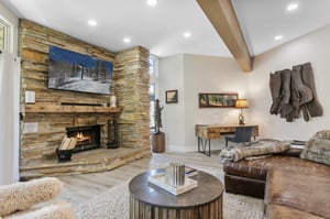 Curl up by the crackling woodburning fireplace and catch your favorite shows on the wallmounted smart TV at Powder Run C13 — a premier Park City lodging destination steps from Deer Valley Resort, w