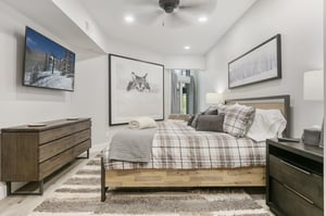 Slip into crisp linens and plaid comforts after a day exploring the slopes. Your bedroom blends rustic warmth with modern simplicity, complete with mountaininspired art and a mounted TV for cozy even