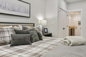 Sink into plush plaid bedding and rustic charm after a day of adventure. Your cozy retreat features soft linens, thoughtful décor, and a private ensuite just steps away.