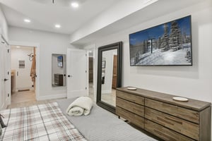 The bright and airy king bedroom at Powder Run C13 offers the perfect mountain retreat, with contemporary furnishings and plenty of space to unwind after a day of skiing or exploring Park City.