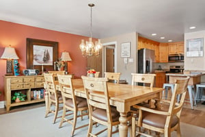 Resort Plaza 5064 is designed for togetherness, featuring a generously sized dining area with elegant chandelier lighting and seamless access to the fully equipped kitchen, making this Park City condo